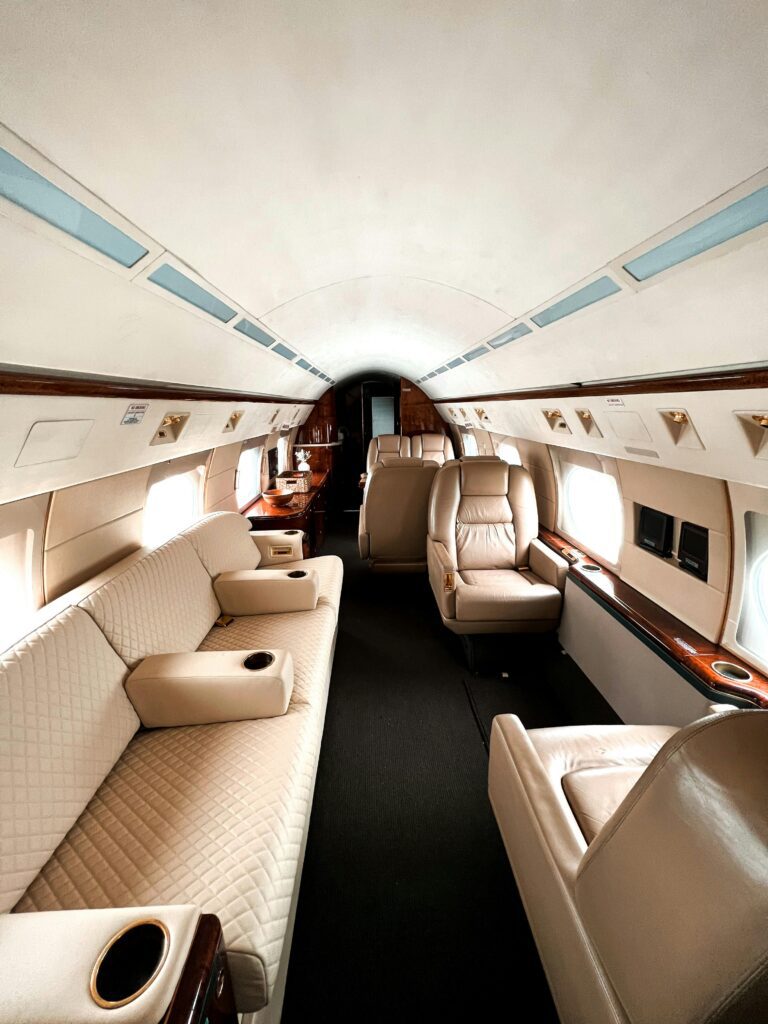 Experience lavish comfort with this elegant private jet interior featuring plush seating and fine craftsmanship.